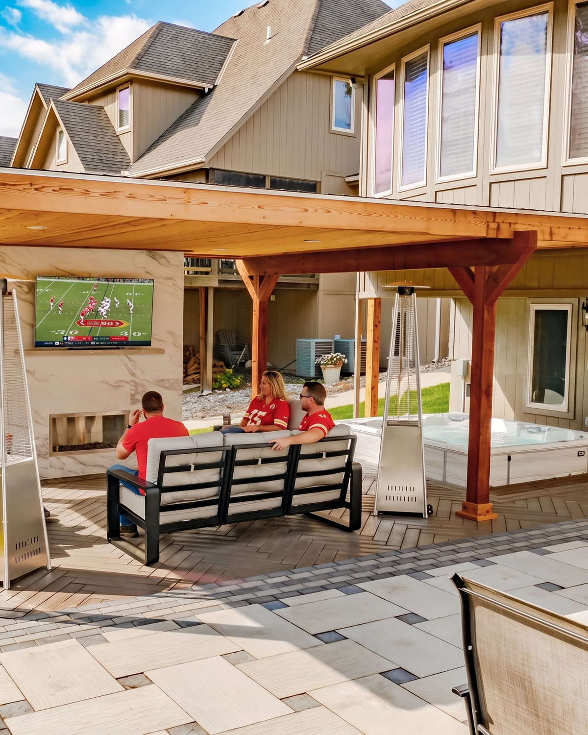 A covered patio set up with an outdoor television for a football watch party